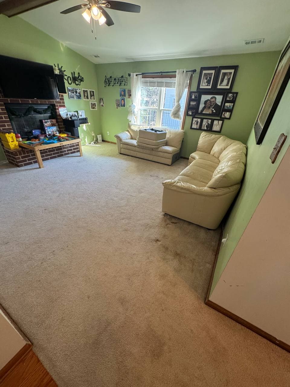 Before and after carpet cleaning in a furnished living room before